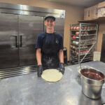 Pizza Palace Wellington - Getting a pizza pie ready. Dough with sauce